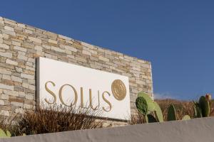 a sign for a soups sign on a brick building at Solus Suites Milos in Adamas