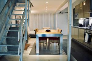 a kitchen and dining room with a table and a staircase at Guesthouse Marie Therese in Brussels
