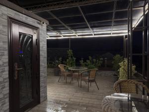 a patio with a table and chairs and a door at Hotel Taht in Tashkent