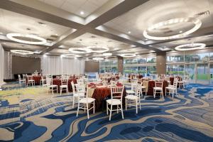 a conference room with tables and chairs in a room at Verta Hotel McAllen Airport in McAllen