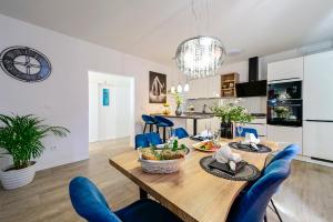 a kitchen and living room with a wooden table and chairs at Holiday Villa Noa in Orebić