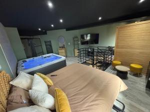 a bedroom with a large bed and a tub at Fratelli Spa in Rocroi