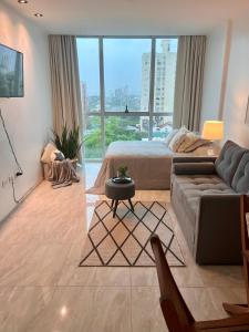 a living room with a bed and a couch at Charlotte Belgrano Posadas in Posadas