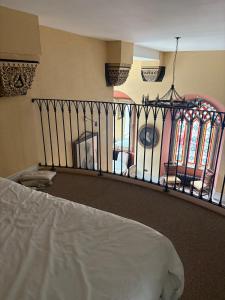 a bedroom with a bed and a balcony at Bastian Gate Gosford Castle 