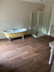 a bathroom with a tub and a glass shower at Bastian Gate Gosford Castle  +11 photos