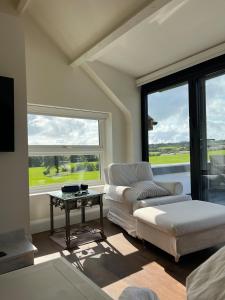 a living room with a couch and a table at Stunning Abersoch Cottage by golf course & beach in Abersoch