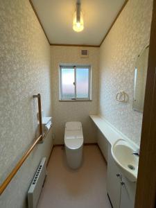 Un baño con inodoro, lavabo y ventana. en 富士view 5LDK 河口湖駅まで徒歩圏内 最大10名で一棟貸し, en Fujikawaguchiko 30 fotos más