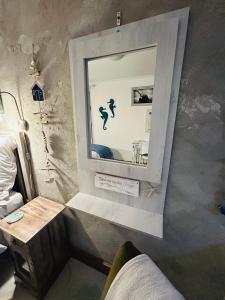 a mirror on the wall of a room with a table at the Lighthouse Beachroom in Cape Town