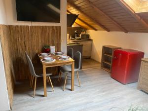 a kitchen with a table and chairs and a red refrigerator at Ferienwohnung Fischer in Rödental in Rödental