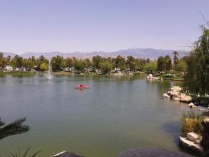 a lake with a red boat in the middle at RV Park at Lakeside Casino in Pahrump