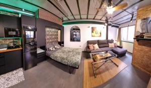 a living room with a couch and a bed at Estudio PIZARRO DOWN TOWN in Torremolinos