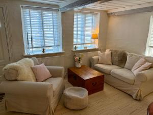 a living room with two couches and a table at Historical Townhouse in Aabenraa