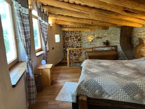 a bedroom with a bed in a room with wooden ceilings at Casuta de lut in Sighişoara