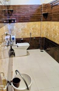 a bathroom with a toilet and a sink at Shangarh JC Snow Valley in Shangarh