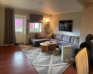 a living room with a couch and a table at Lillian's gjestehus, Skibotn in Skibotn