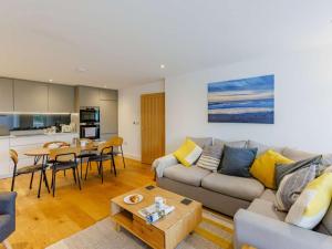 a living room with a couch and a table at 2 Bed in Bude 90096 in Bude