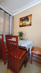 a dining room with a table and two chairs at Serenity Homes in Kampala
