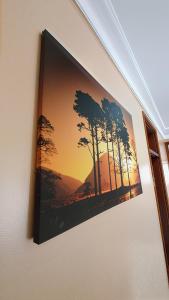 a picture hanging on a wall with a picture of trees at Serenity Homes in Kampala