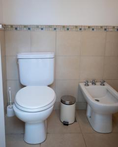 a bathroom with a toilet and a sink at Altos de Ventana in Sierra de la Ventana +20 photos