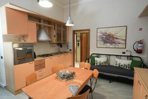 a kitchen and dining room with a table and a couch at MONOPOLI MIA in Monopoli