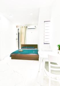 a bedroom with a bed and a desk and a chair at Kim's Studio District 1 in Ho Chi Minh City