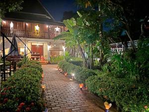 a brick walkway in front of a house at night at Luang Prabang Residence - The Boutique Villa in Luang Prabang