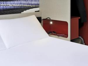 a bedroom with a bed and a fireplace at ibis Styles Lille Centre Grand Place in Lille