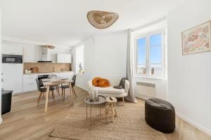 a white living room with a couch and a table at Bord de l'Eau 4 in Cancale