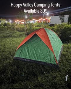 a green and orange tent sitting in the grass at Happy Valley Camping Tents in Araku