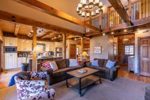 a living room with couches and a table at Gratitude in Blowing Rock