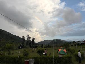 a group of people flying a kite in a field at Happy Valley Camping Tents in Araku