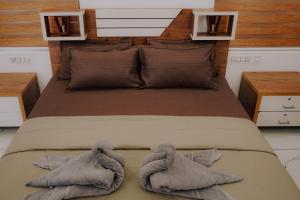 a bedroom with a bed with towels on it at The Kalt Private Pool Homestay Munnar in Anachal +20 photos