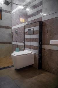 a bathroom with a white toilet and a shower at The Kalt Private Pool Homestay Munnar in Anachal