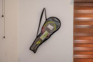 a tennis racket is hanging on a wall at The Kalt Private Pool Homestay Munnar in Anachal