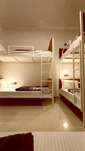 a room with two bunk beds and a room with at Shaanti Coliving in Rishīkesh