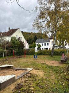 a park with a bench and a playground at Ferienwohnung in Merzig City an der Saar in Merzig