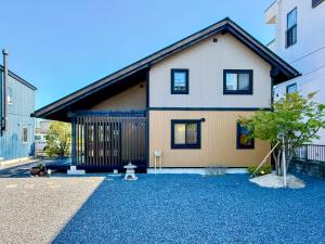 a house on a street with a gravel yard at yado suzuka 1 in Suzuka
