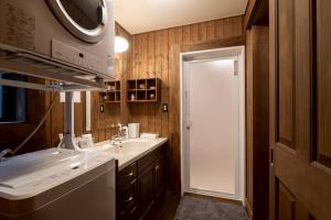 a bathroom with a sink and a washing machine at yado suzuka 1 in Suzuka +44 photos