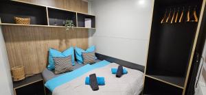 a bedroom with a bed with blue pillows at Doris in Pakoštane