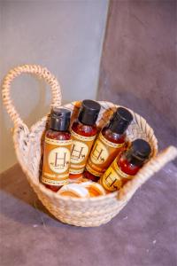 a basket filled with bottles of honey on a table at Luxury Desert Tents - Agafay Experience in Aït Mazou