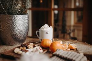 a table with a cup of whipped cream and fruit at Appartements Gut Berg in Sankt Johann im Pongau +19 photos