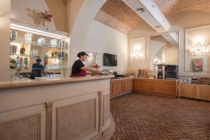 a man standing at a counter in a kitchen at Hotel Flavia in Rome
