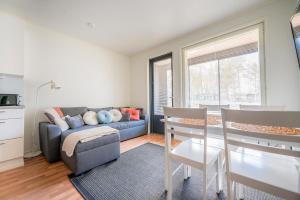 a living room with a couch and a table at Auringonsäde Apartments in Kalajoki