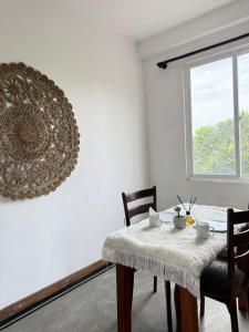 a dining room with a table and chairs and a window at Olaia Apartments and Cafe in Weligama +18 photos