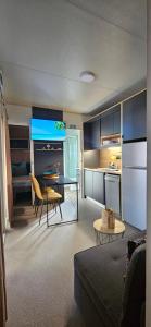 a kitchen and a living room with a table and chairs at Doris in Pakoštane