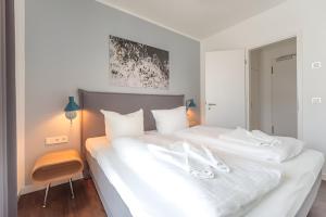 Postel nebo postele na pokoji v ubytování Quartier Schneespecht Westendpalais