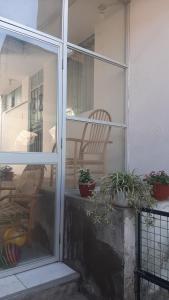 a sliding glass door to a patio with potted plants at Mini Apartamento acogedor in Miraflores