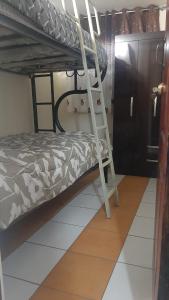a bedroom with a bunk bed and a ladder at Mini Apartamento acogedor in Miraflores