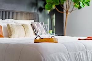 a couple of white beds with glasses on them at Short North Convention King Bed Free Parking! in Columbus +63 photos