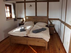 a bed in a room with two towels on it at Ferienwohnung Koppelblick in Pfarrweisach +15 photos